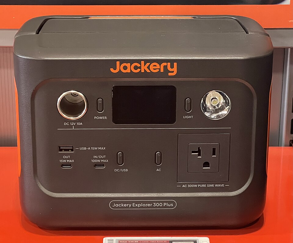 A dark gray Jackery Explorer 300 Plus power station with a display, USB ports and an AC outlet on the front, for storm prep in Hiawatha, IA