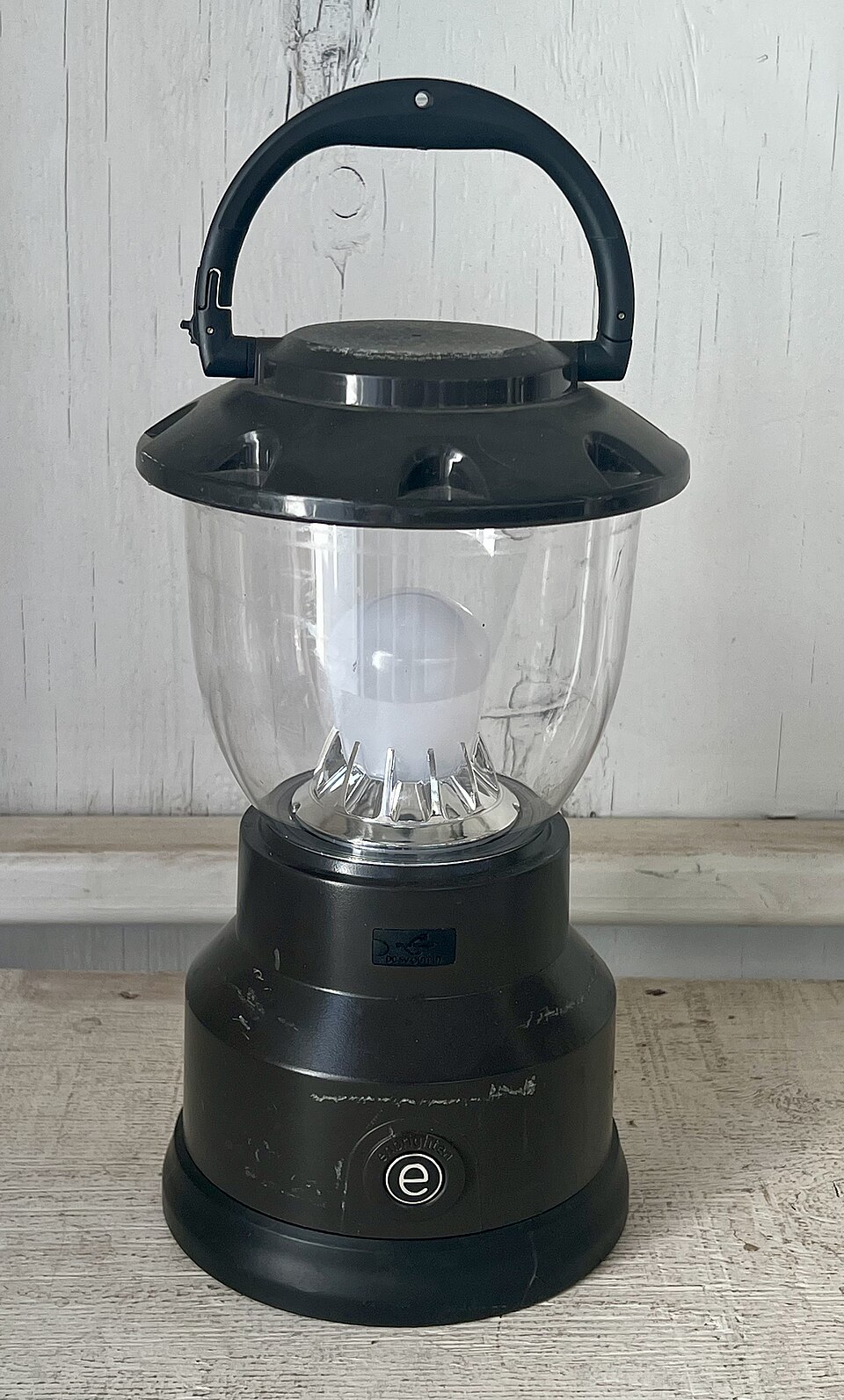 A black LED camping lantern with a clear globe and a top carry handle, for storm prep in Hiawatha, IA