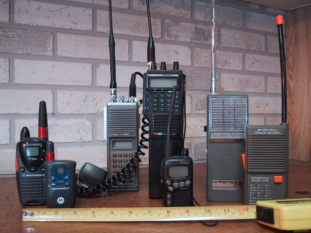 Several handheld walkie-talkies of different makes standing side by side, for storm prep in Hiawatha, IA